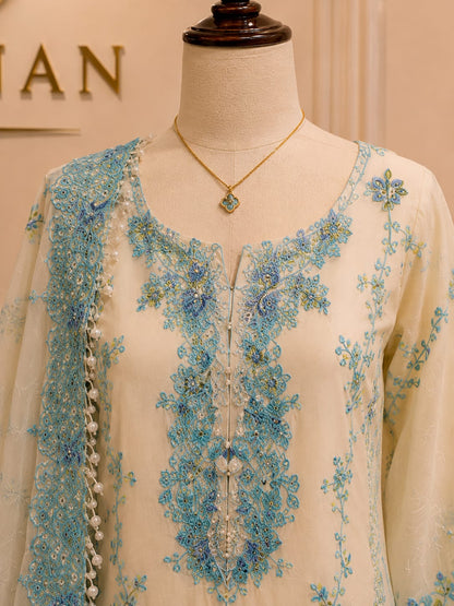 Close-up of sky blue embroidery on ivory women's 3 piece formal suit