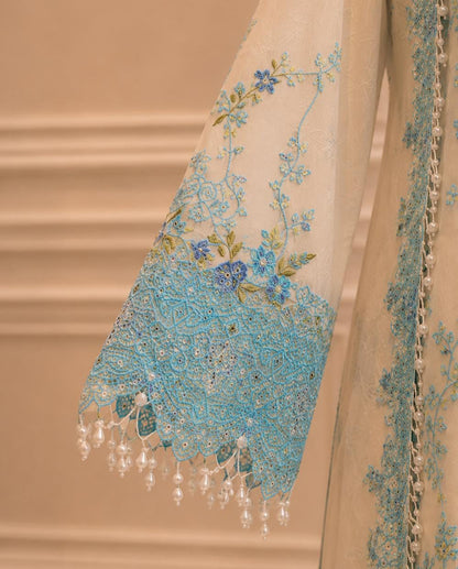 Sky blue embroidery detail on sleeve of ivory formal suit